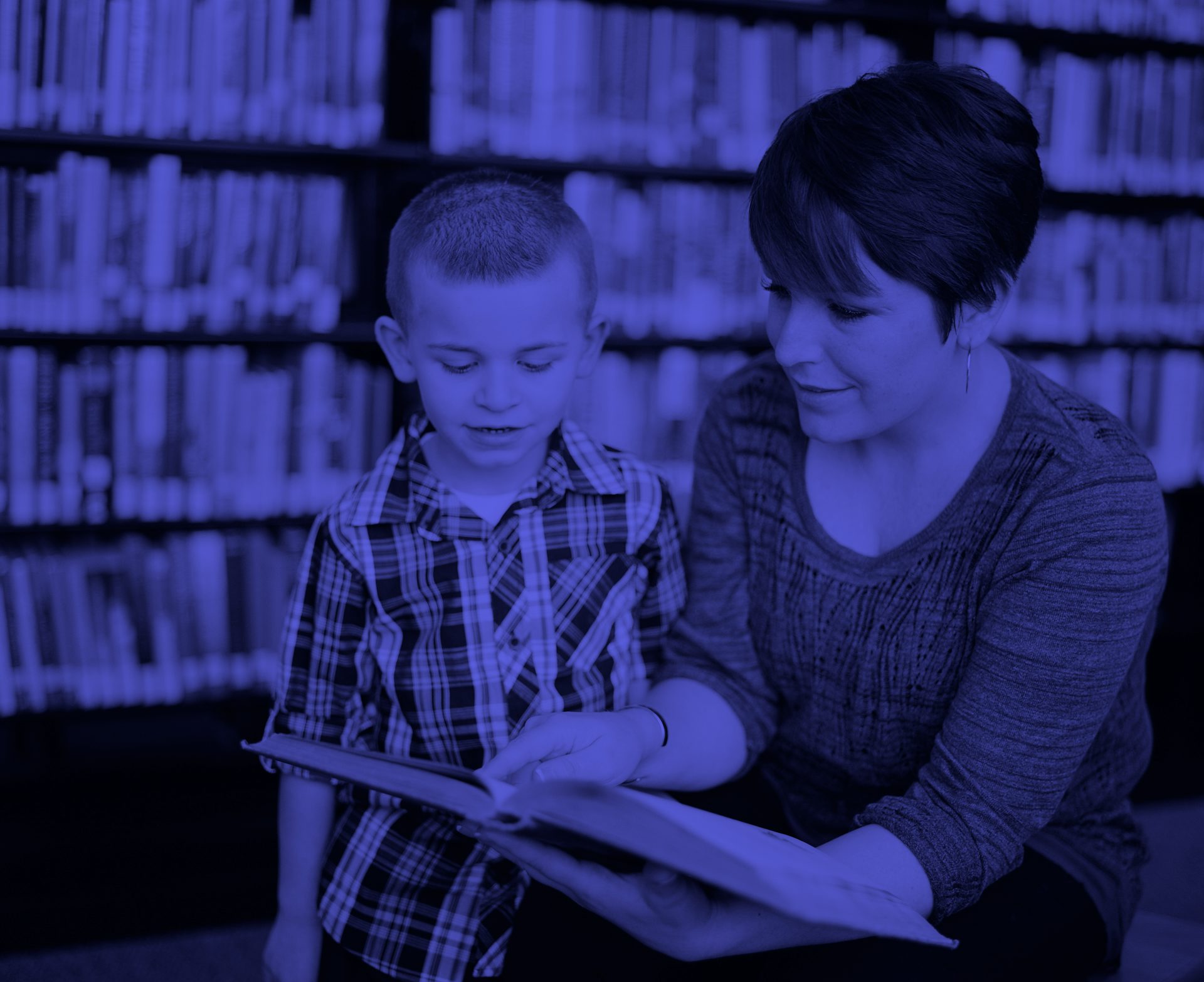 Woman and child reading a book